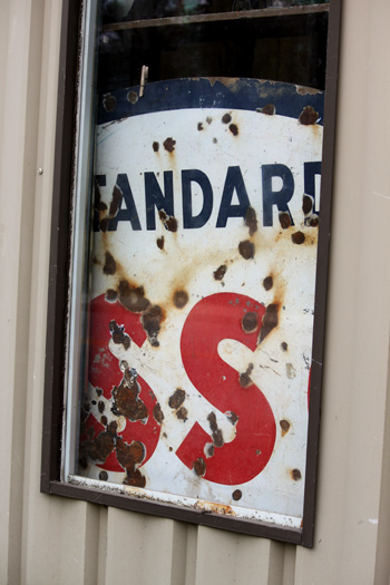 rusty antique sign in a window