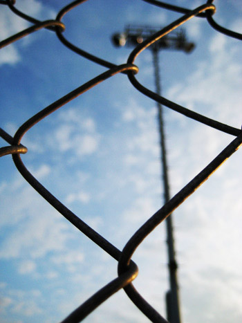 fence and the lightpost and sky beyond
