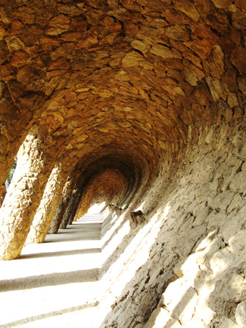 wave-like archway at parc guell in barcelona, spain