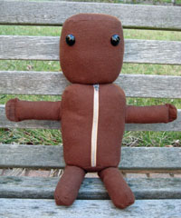 handmade plush sackboy from the game littlebigplanet, sitting and ready for a hug