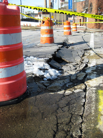 broken street and caution tape (post water main break) broken street and caution tape (post water main break)
